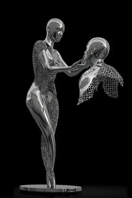 Metallic sculpture of a figure holding a butterfly against a black background